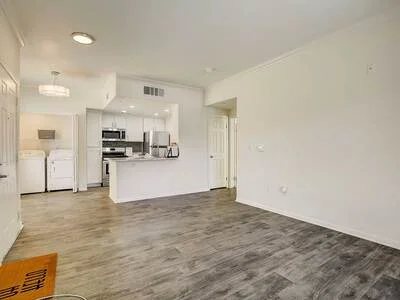 Living area showing open layout and in-unit laundry