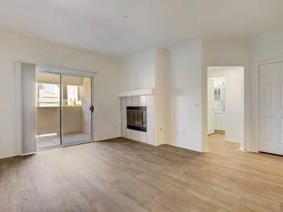 Living room with patio doors and wood-inspired flooring
