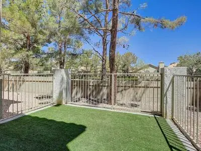 Gated community entrance with lush landscaping